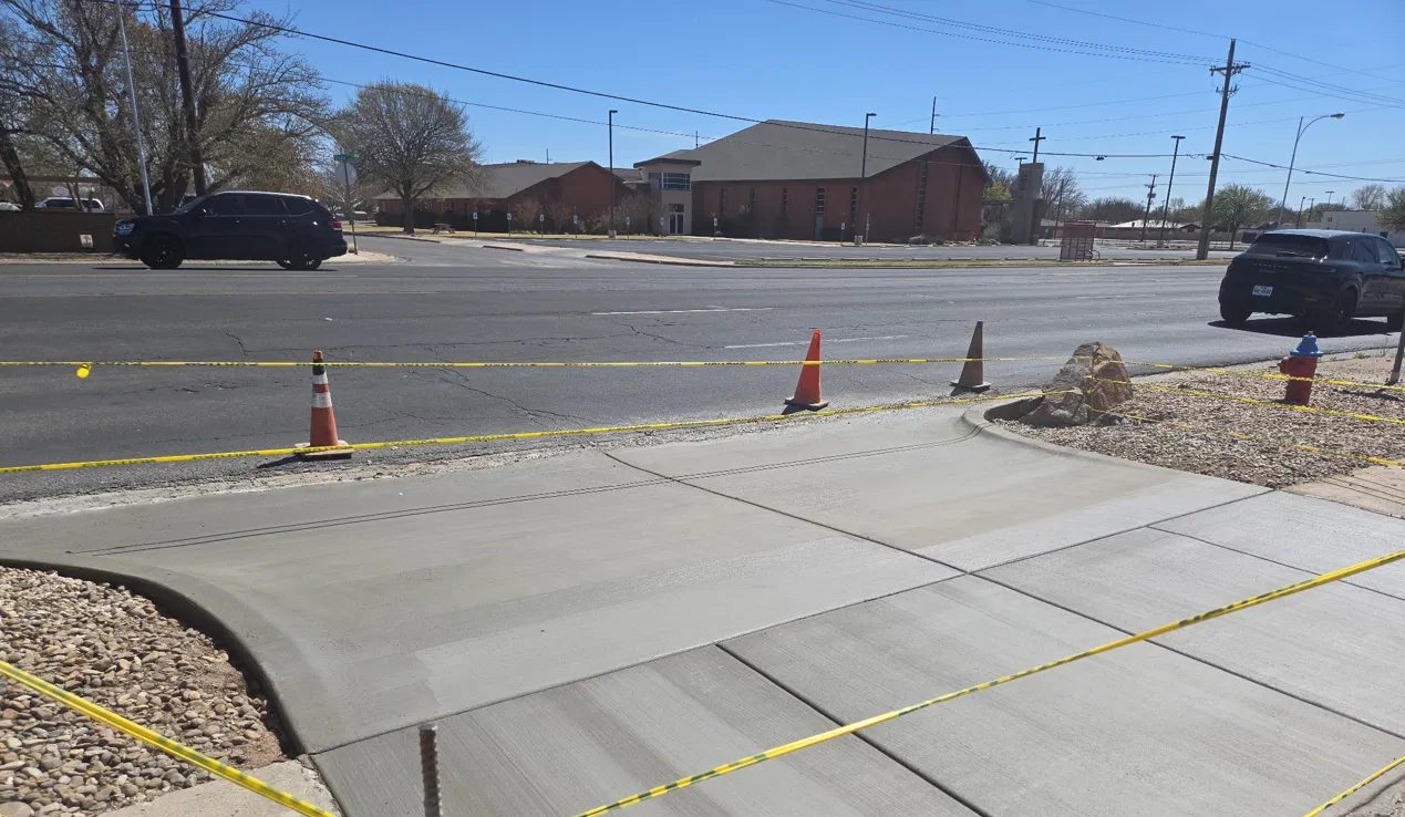 New sidewalk and drive approach with curved curb returns along a Lubbock street